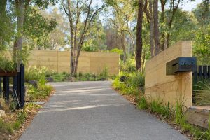 Rammed earth letter box post and landscaping entry walls