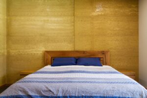 internal-rammed-earth-bedroom-feature-wall