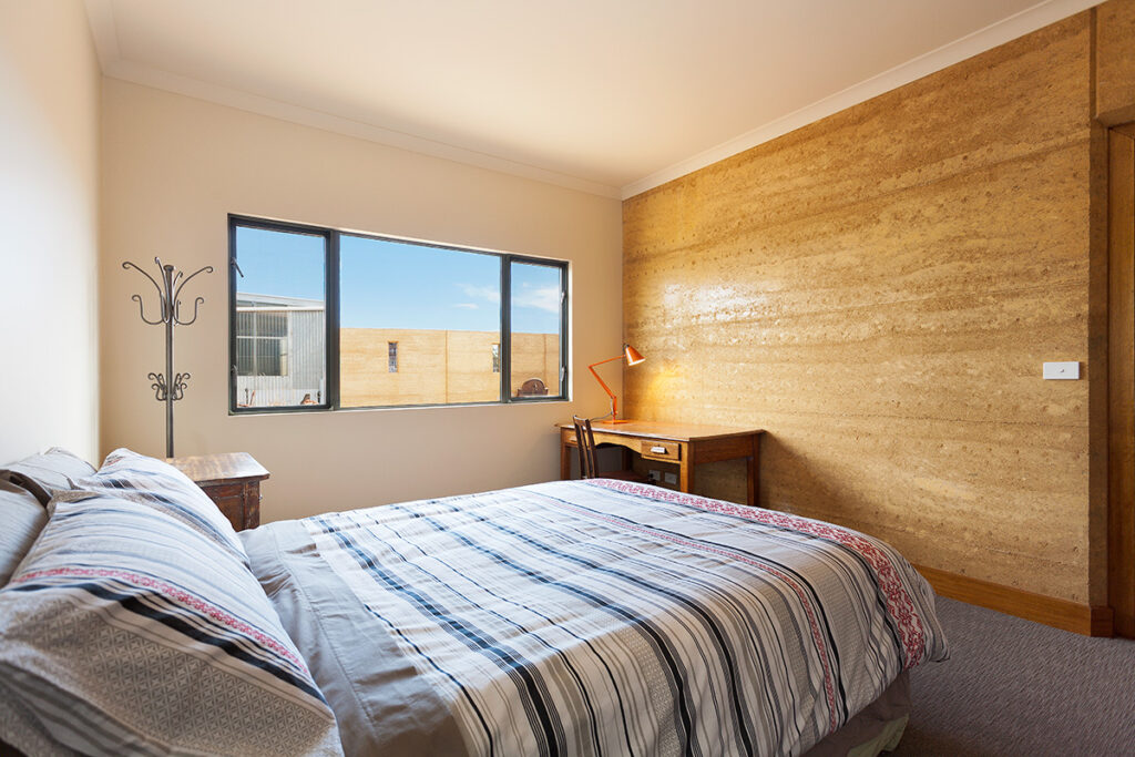 internal-rammed-earth-bedroom-feature-wall